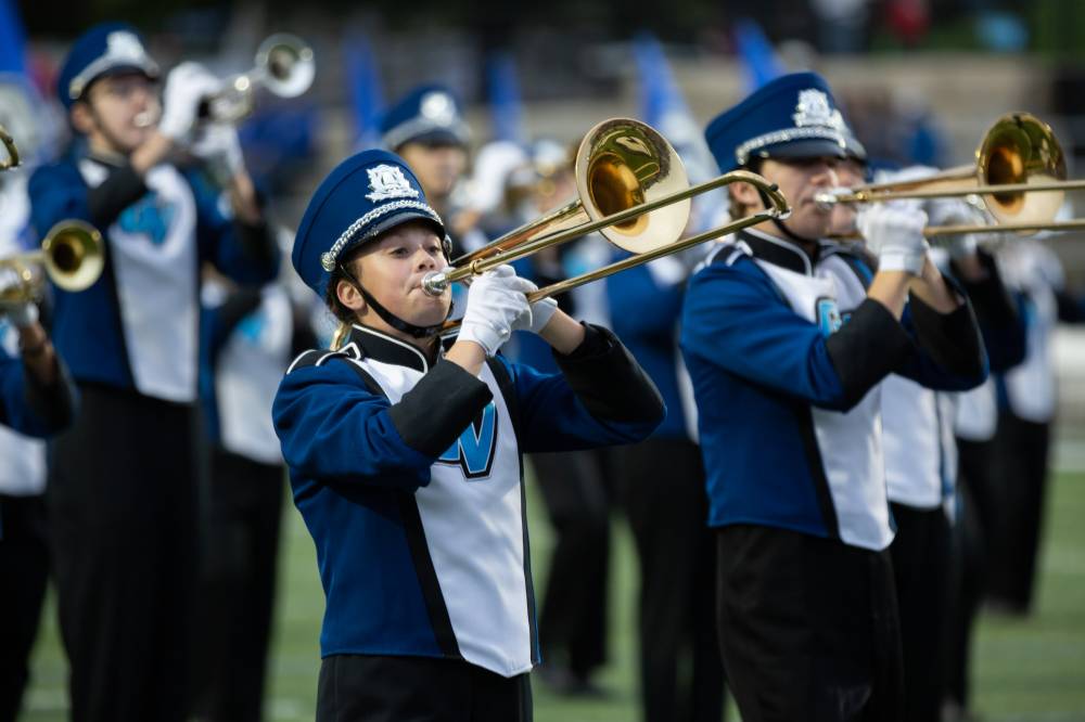Trombone players perform during halftime at Lubbers Stadium